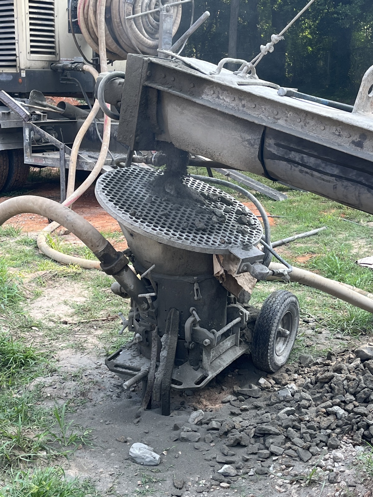 Gunite hopper and shotcrete equipment on a pool jobsite