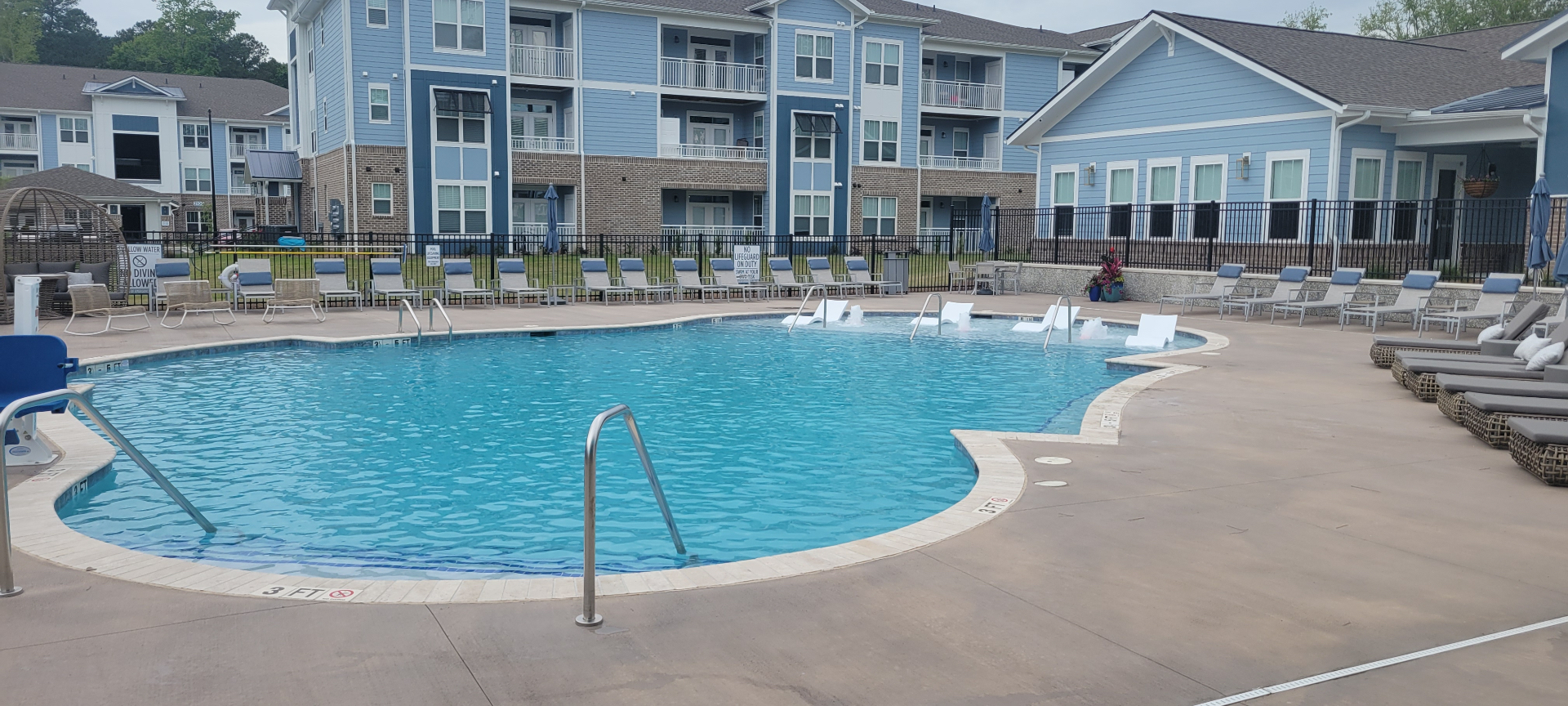 Finished pool area with in-water loungers, sun shelf, and resident lounge seating along the deck.